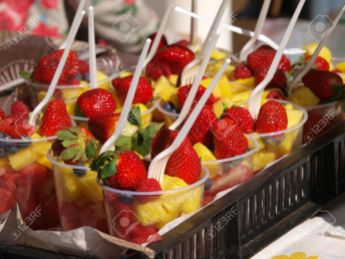 mixed fruit salad in plastic cups on open market of Portobello road